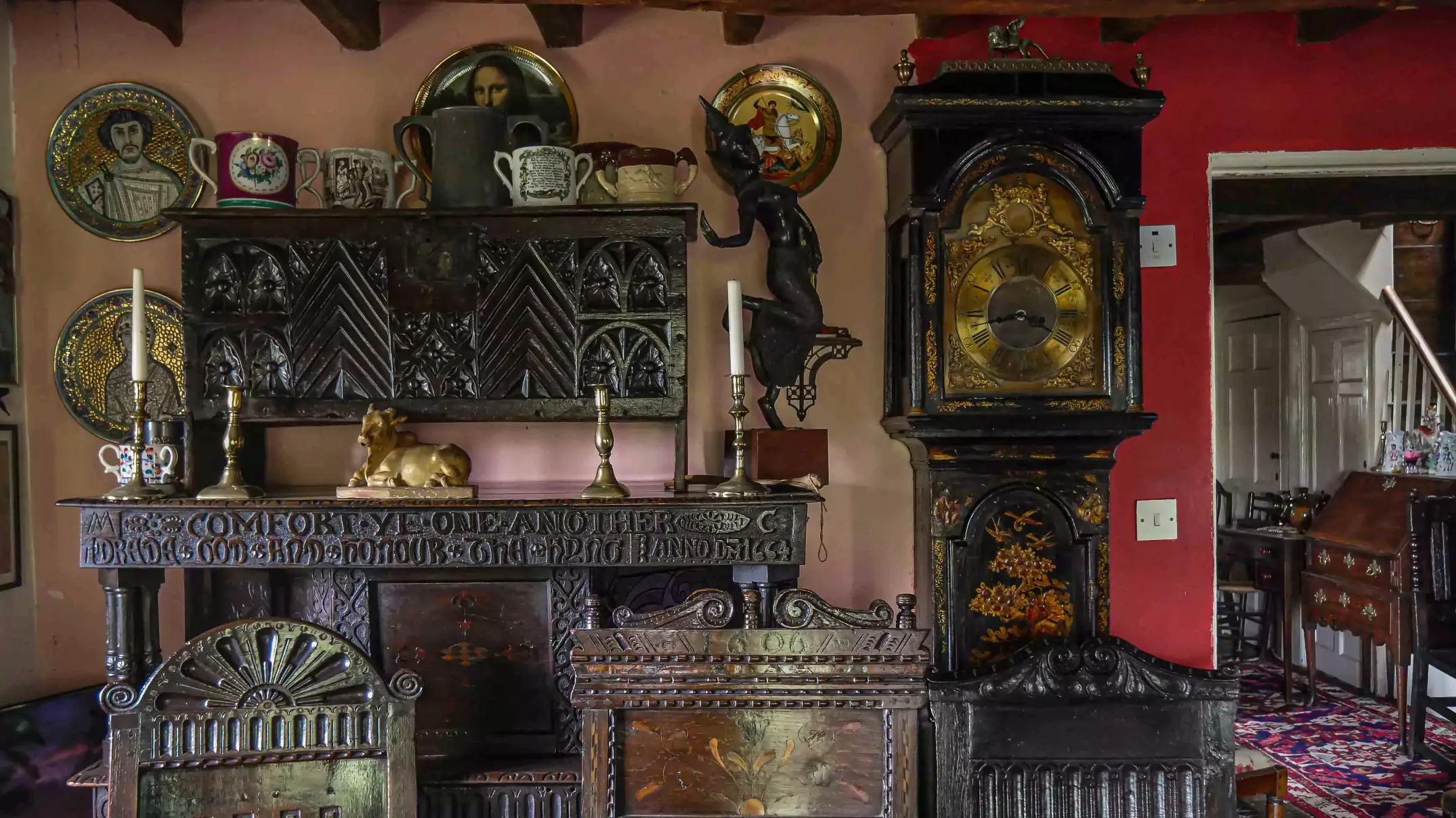 photo of one of the bedrooms. In the photo there are so exotic figurines and artifacts sitting upon old chests and fronted by some carved chairs