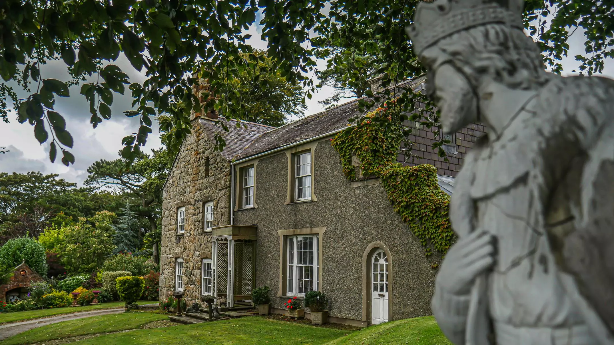 photo showing a side profile of the house where you can clearly see where the georgian extension meets the old stone house