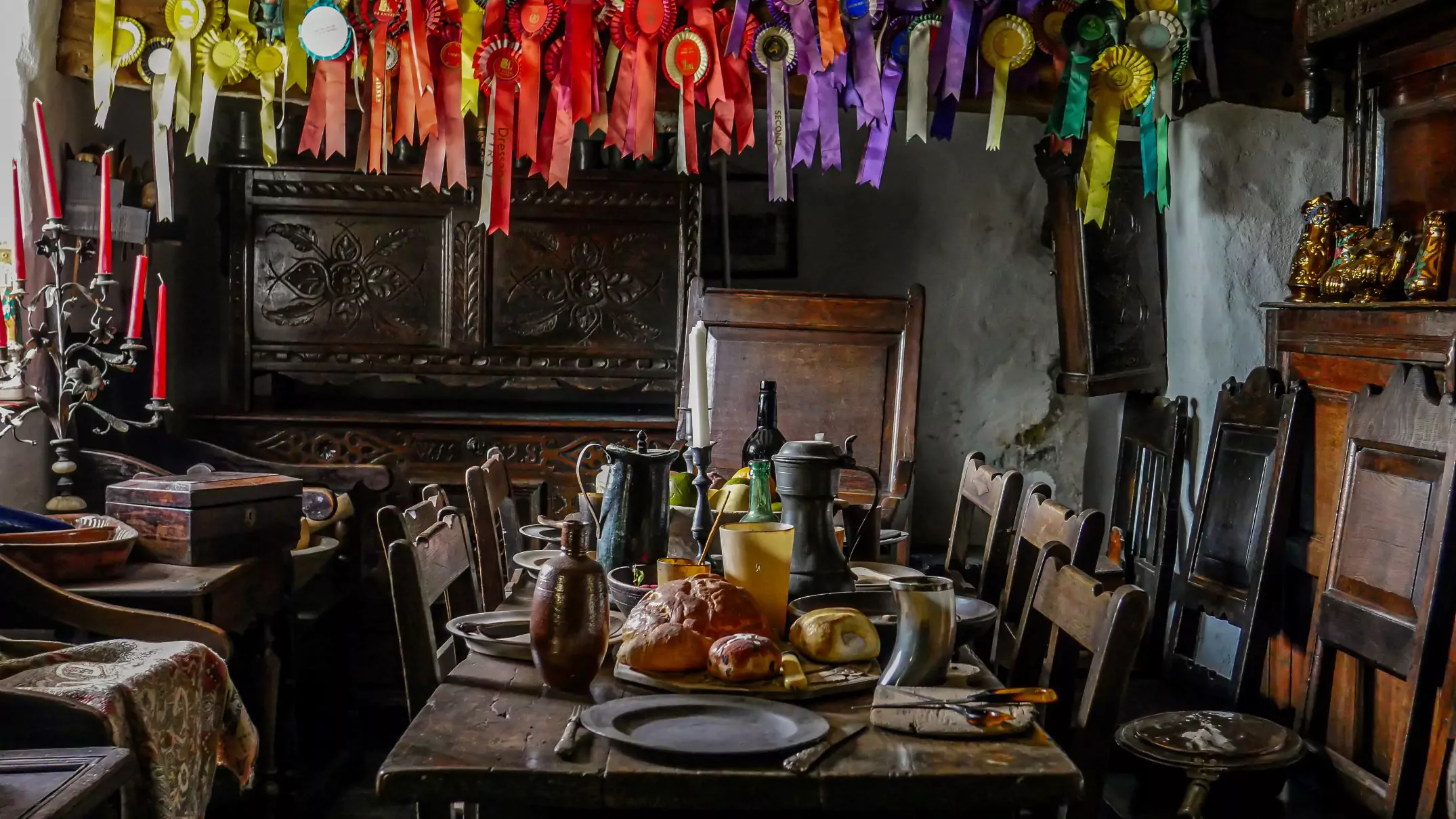 the old kitchen which now houses welsh period furniture, photo of a table set ready for a buffet